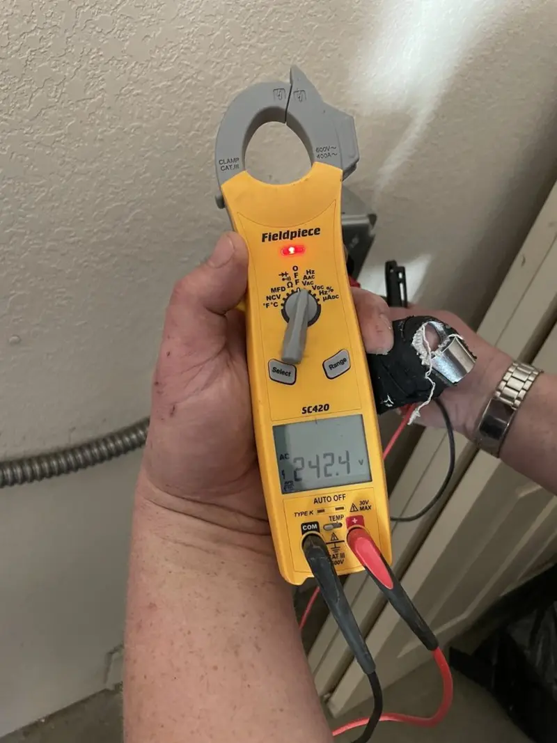 Voltage testing with clamp meter during Recessed Lighting Installation in Morris